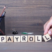 payroll. Wooden letters on dark background